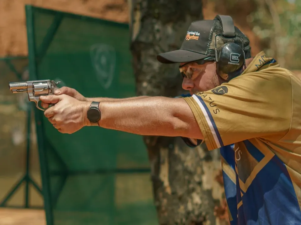 Max-Wilhelm Rossle shooting a revolver at a sport shooting range
