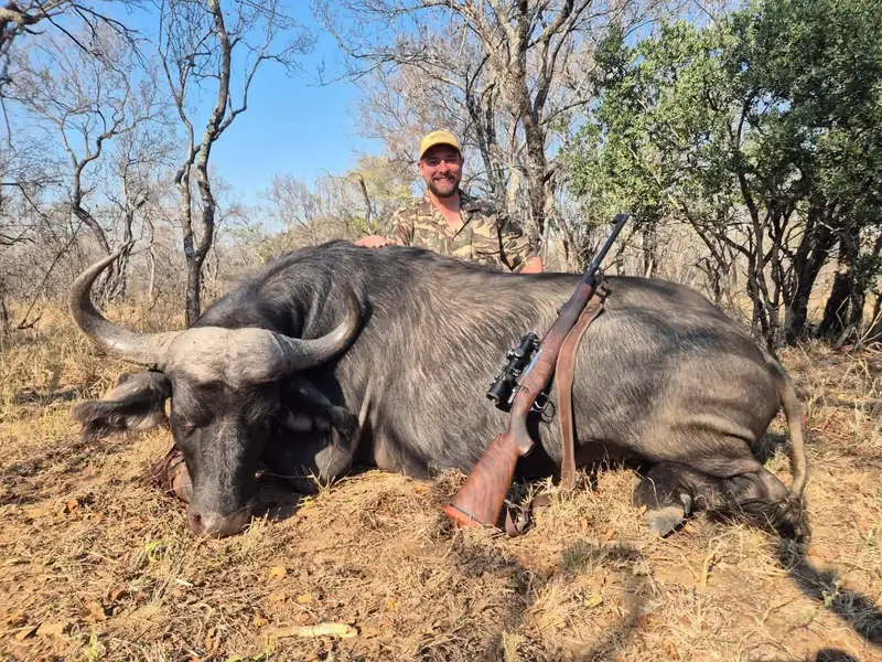 Max-Wilhelm Rossle in the bushveld with a buffalo and his hunting rifle
